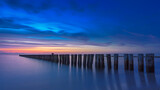 Image. Sunset over baltic sea breakwaters